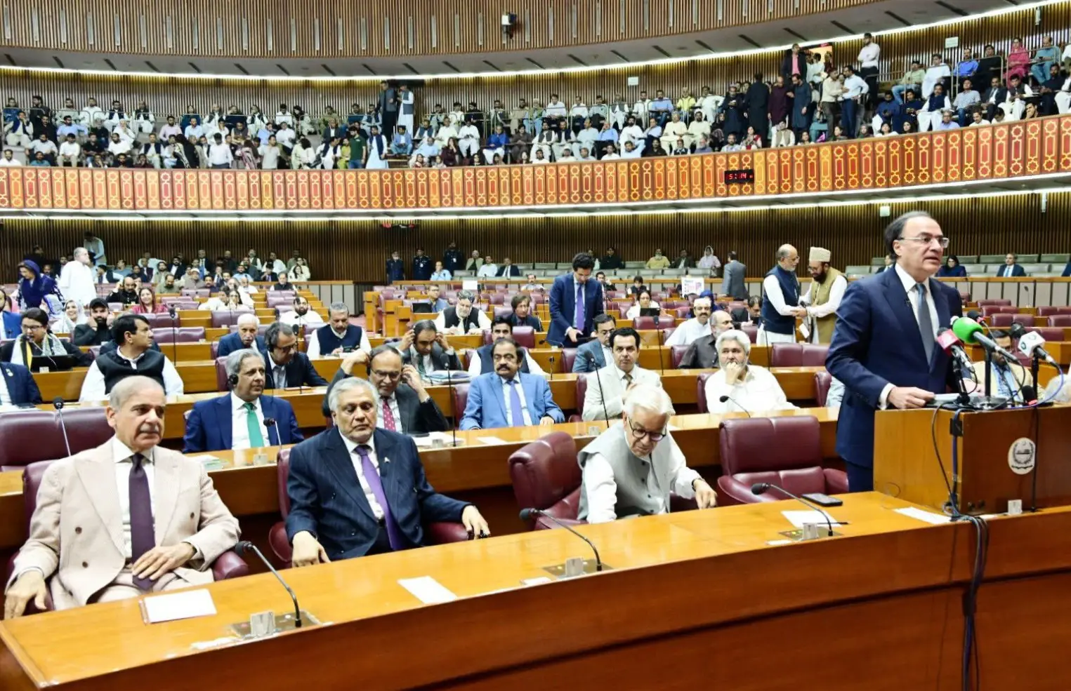 Pakistan’s Prime Minister Shehbaz Sharif listens as Finance Minister Muhammad Aurangzeb delivers the FY2026-27 federal budget speech on June 12. Photo Credit: National Assembly of Pakistan.